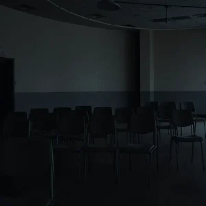 Somber prison visitation room reflecting an atmosphere of loss.