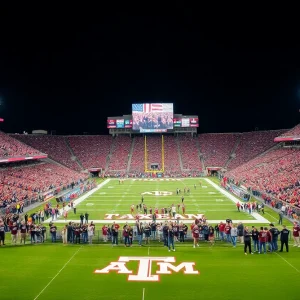 Crowd cheering in a Texas A&M football stadium at night