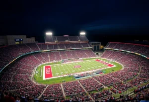 A vibrant night game at Kyle Field featuring college football fans and stadium lights