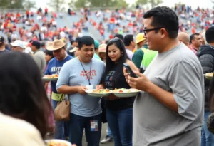 Community gathering at A Toda Madre Tailgate celebrating Hispanic Heritage Month